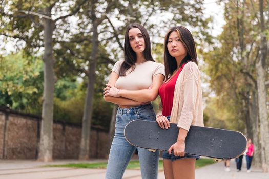 two young women posing serious looking at camera, concept of female friendship and teenager lifestyle, copy space for text