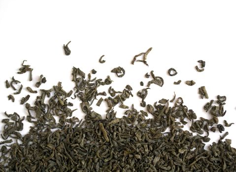 Dried green leaf tea. Green leaf tea on a white background close-up.