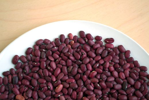 Red dried beans in a bowl. Red dried beans in a plate, texture, background.