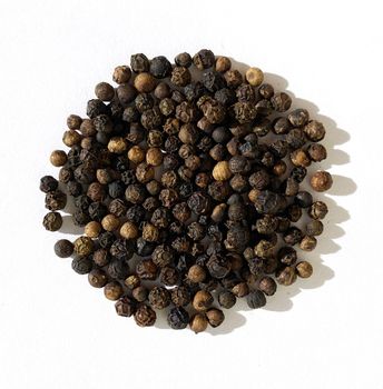 Texture, background. Black peppercorns on a white background, seasoning.