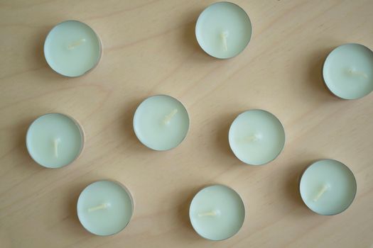 White candles. White candles on a wooden table close-up.