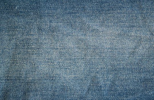 Background, texture, denim. Close-up photo of blue denim fabric