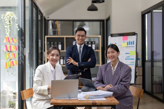 Portrait happy group of Asian business people meeting for start up project with colleagues look at camera and smile