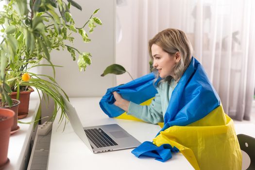 woman with flag of Ukraine and laptop.