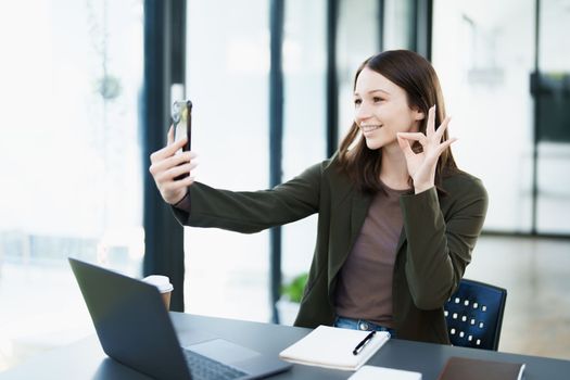business owner or Asian female marketers are using business phones in office work.