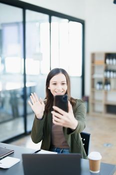 business owner or Asian female marketers are using business phones in office work.