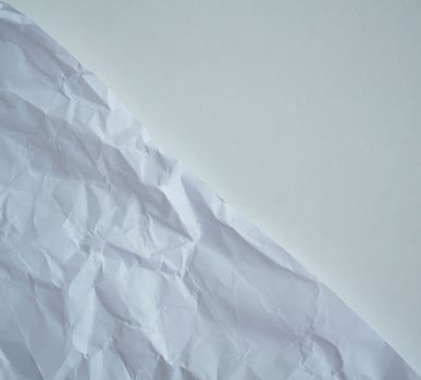 Texture, background. White crumpled paper, close up.