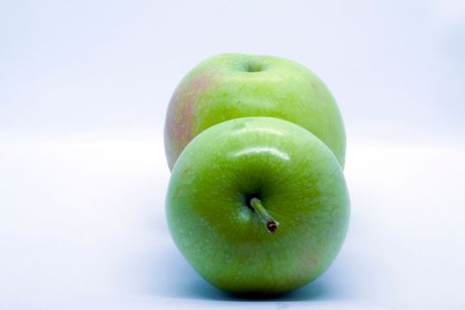 Two green apples on a white background close-up.