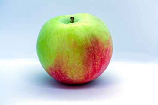 Red-green apple on a white background close-up.