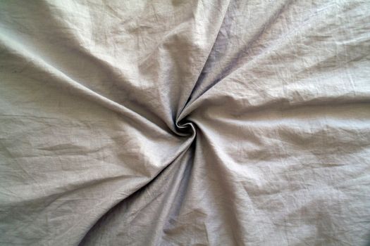 
Background, texture, gray wrinkled fabric, cotton. Photo of a gray crumpled fabric in the form of a spiral.