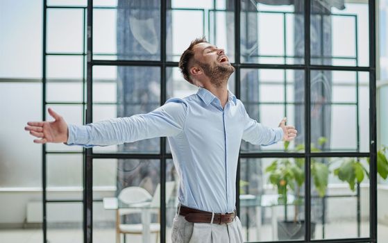 Portrait of young businessman wearing and standing outside conference room