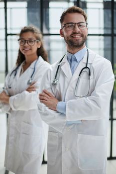 Close-up of a smiling male and female doctor,
