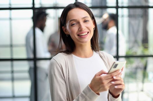 Businesswoman sitting in office, talking on the phone