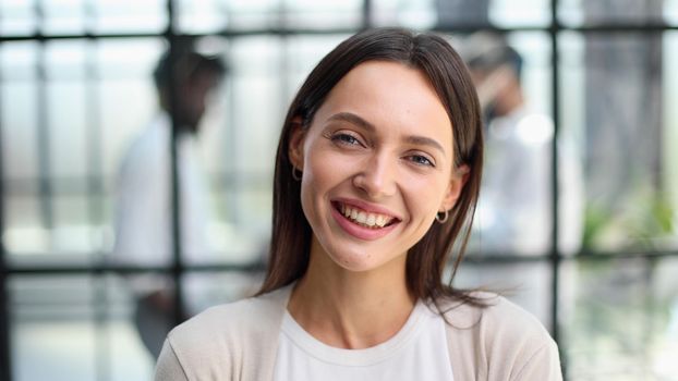 Face of beautiful woman on the background of business people