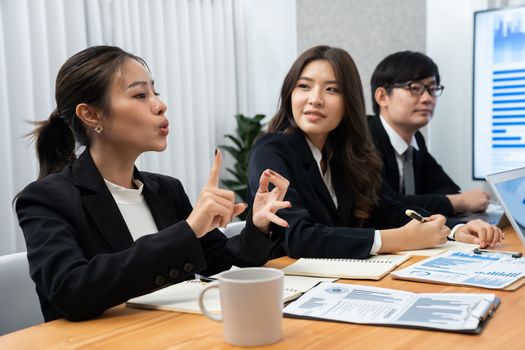 Business team of financial data analysis meeting with business intelligence, report paper and dashboard on laptop for marketing strategy. Business people working together to promote harmony in office.