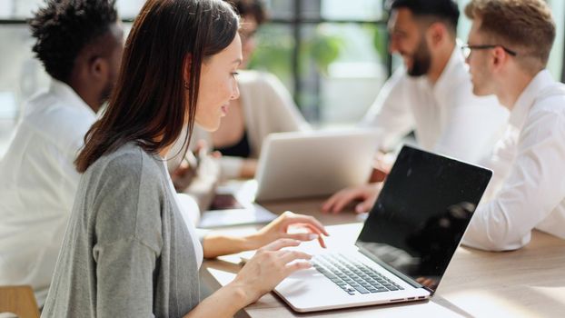 Face of beautiful woman on the background of business people