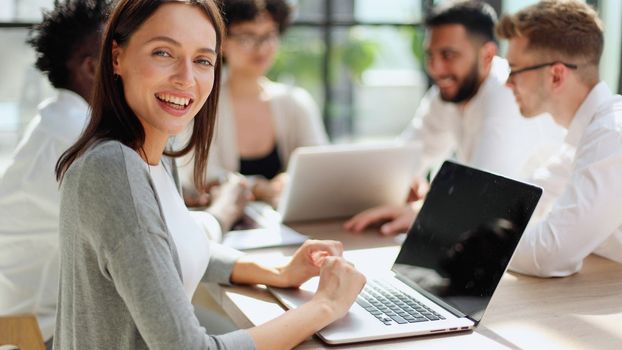 Face of beautiful woman on the background of business people