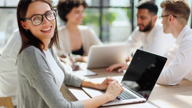 Face of beautiful woman on the background of business people