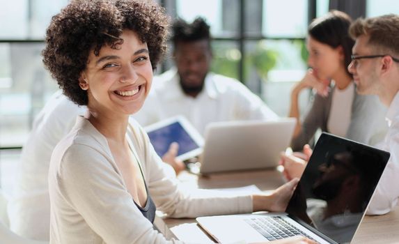 Face of beautiful woman on the background of business people