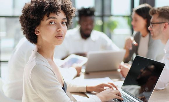 Face of beautiful woman on the background of business people