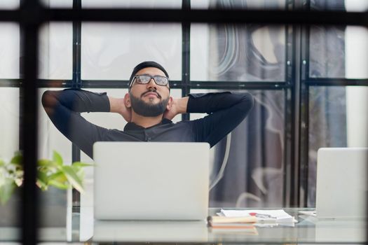 Middle-aged man working on laptop in office