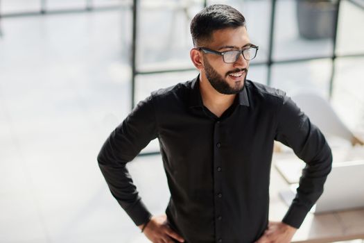 Businessman portrait. Happy confident young businessman standing , smiling, looking at camera.