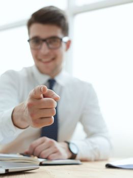 businessman pointing his finger to you at office