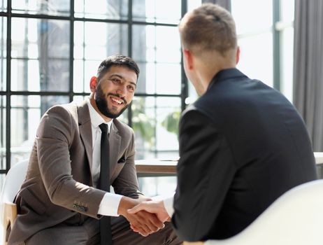 Successful business people handshaking after good deal.