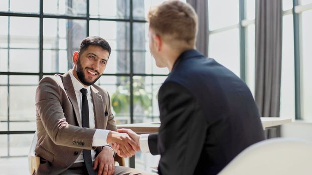 Successful business people handshaking after good deal.