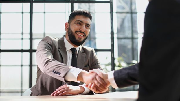 Successful business people handshaking after good deal.