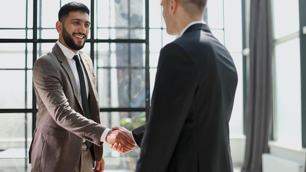 Successful business people handshaking after good deal.