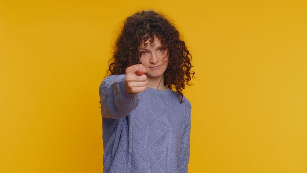 Angry aggressive young woman showing fig negative gesture, you dont get it anyway. Rapacious, avaricious, acquisitive. Body language. Refusal fig sign. Greedy avaricious girl on yellow background