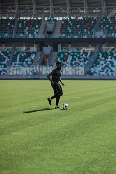 Professional football player in action at the stadium. The concept of sport, competition, movement, overcoming. The effect of the presence of the field.