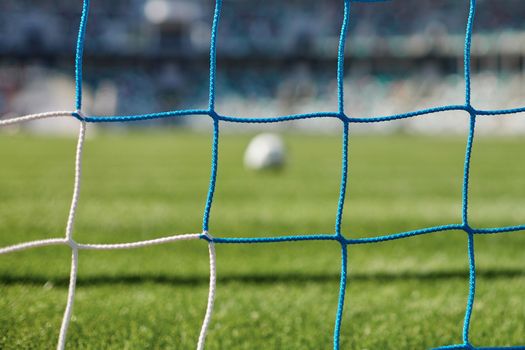 Football goal post with net, back view. Association football goal on the field