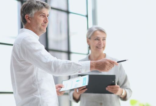 Businessman and woman working on computer together