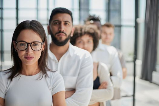 Face of beautiful woman on the background of business people