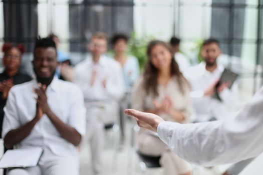 Selective focus of lecturer talking to audience during seminar in conference room