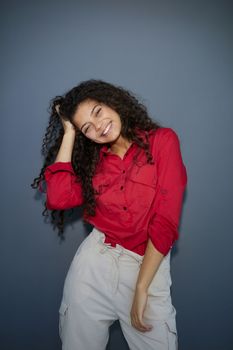 Happy young business woman posing isolated over grey wall background.