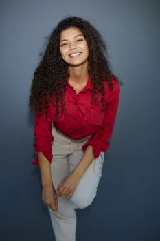 Happy young business woman posing isolated over grey wall background.