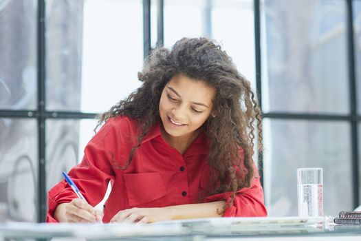 Portrait of an attractive cheerful experienced girl advising clients on customer service in the office