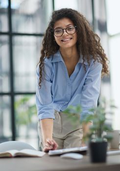 A young woman makes a report in the office. Woman writing notes for educational project in business