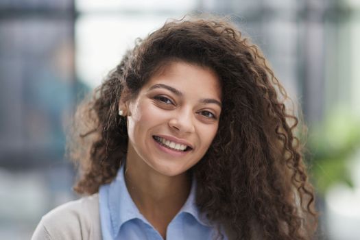 Portrait of young smiling woman looking at camera