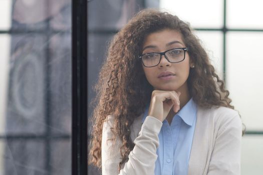 Business woman in the office outside the window