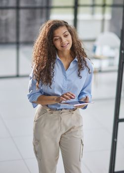 millennial girl employee holding modern tablet device feels happy enjoy break at workplace