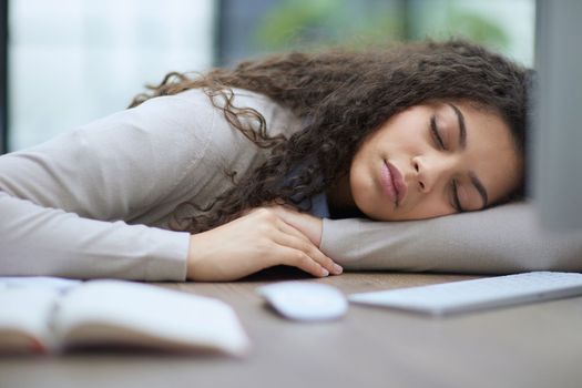 Portrait of a beautiful business woman sleeping on the table in the office