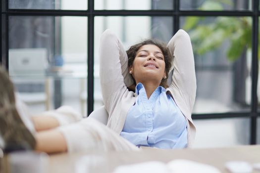Tired businesswoman sleeping with closed eyes at workplace in office