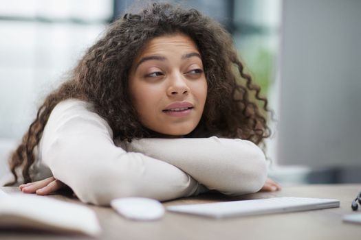 Portrait of a beautiful business woman sleeping on the table in the office