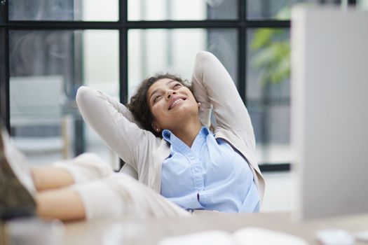 Tired businesswoman sleeping with closed eyes at workplace in office