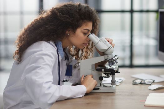 Female scientist researcher conducting an experiment in a labora