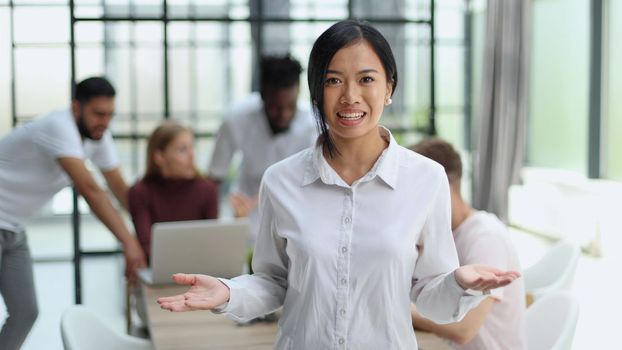 young successful businesswoman in white shirt smiling in the office